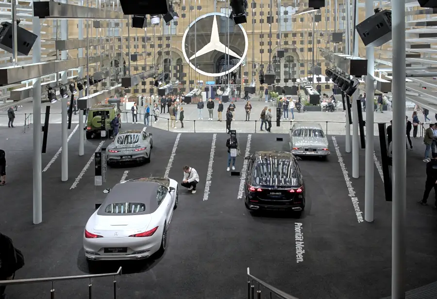 Mercedes-Benz Open Space at IAA Mobility 2025 in Munich: cars and visitors in a courtyard beneath a large Mercedes star