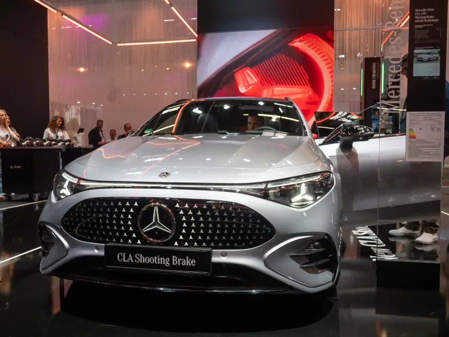 Mercedes-Benz at IAA Summit 2025 in Munich: CLA Shooting Brake in front, a light wall and visitors behind