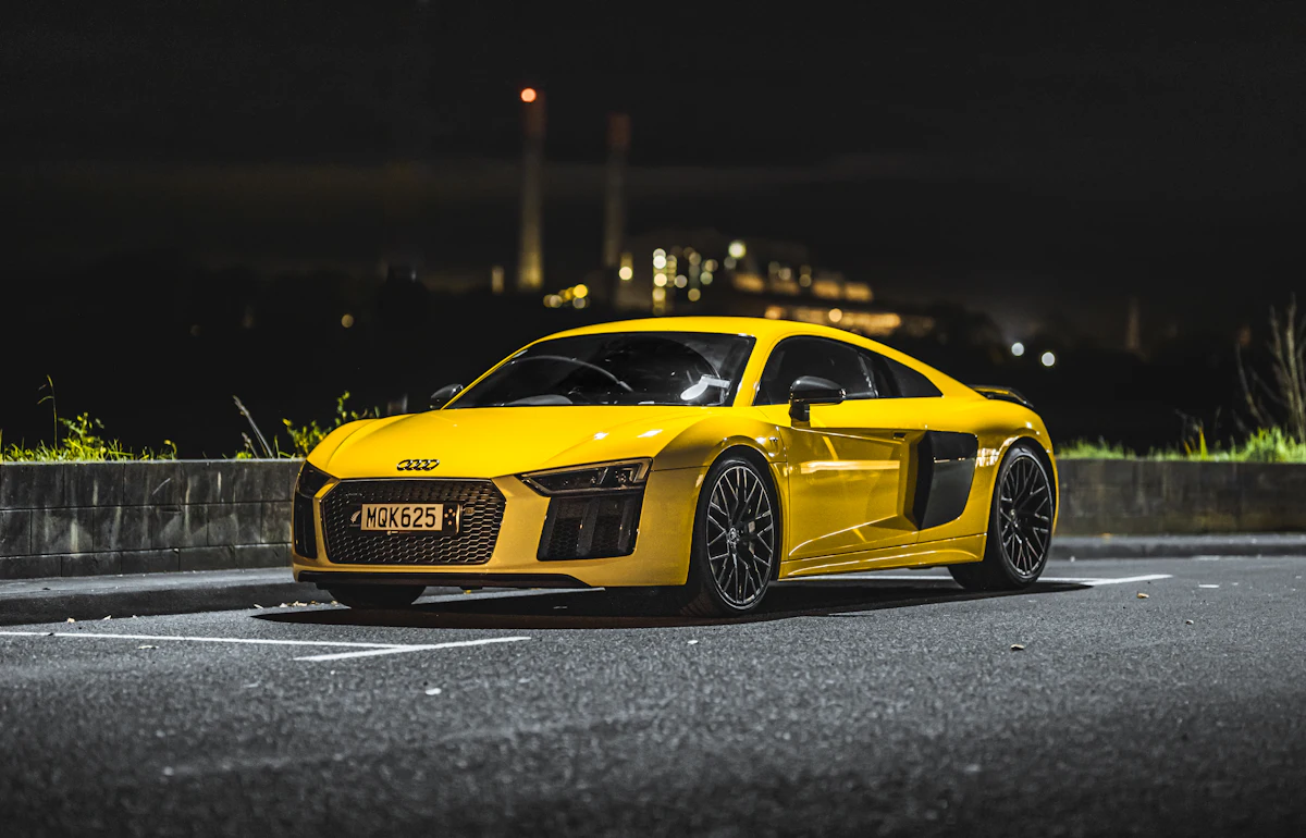 Yellow sports car at night