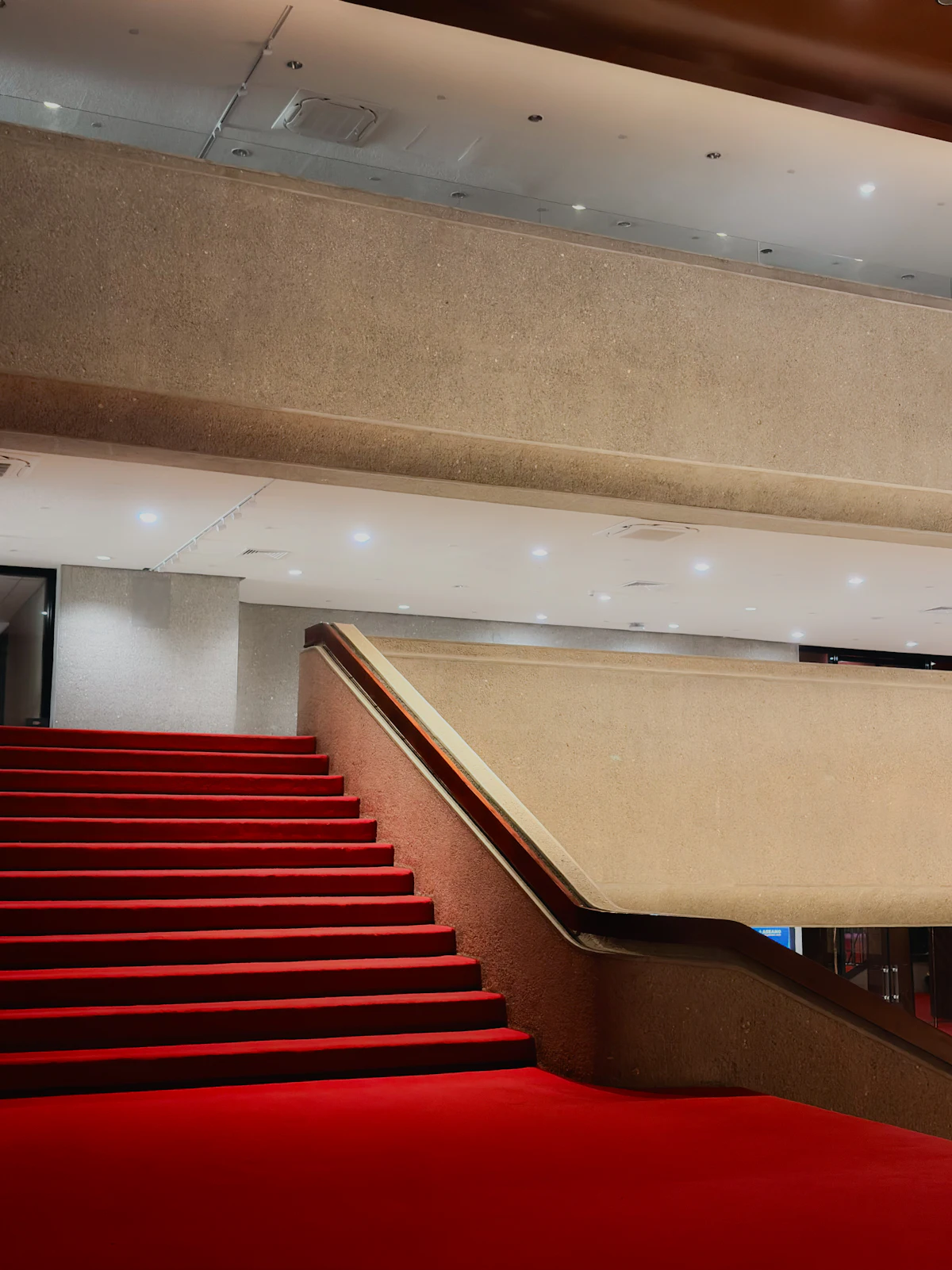 Staircase with a red carpet in a grand foyer