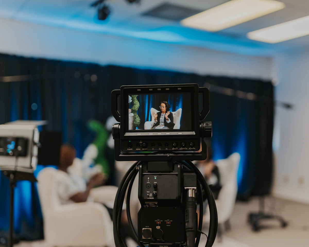 Broadcast camera with meeting attendees in the background